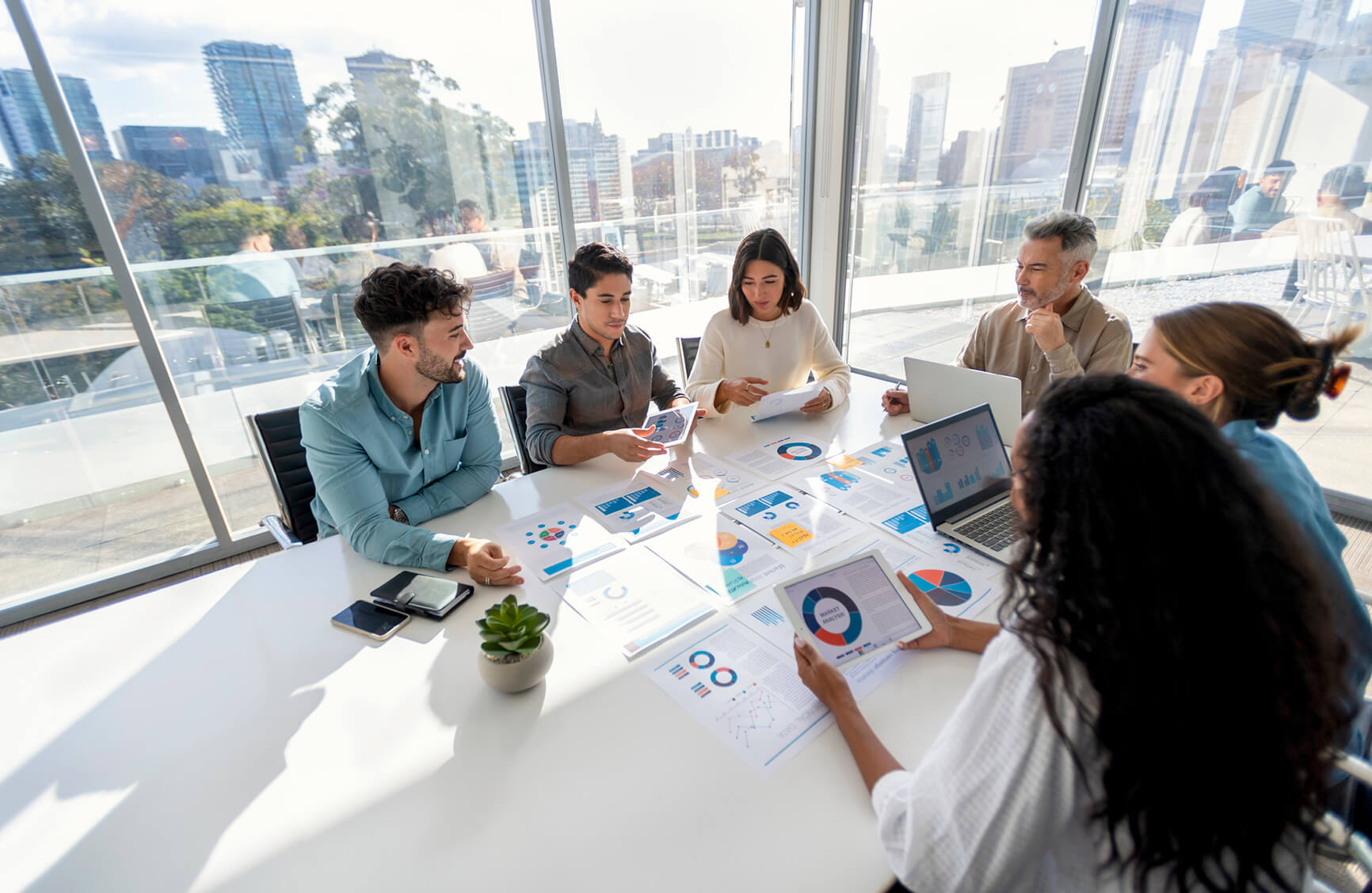 photo of people in office meeting room reviewing a presentation