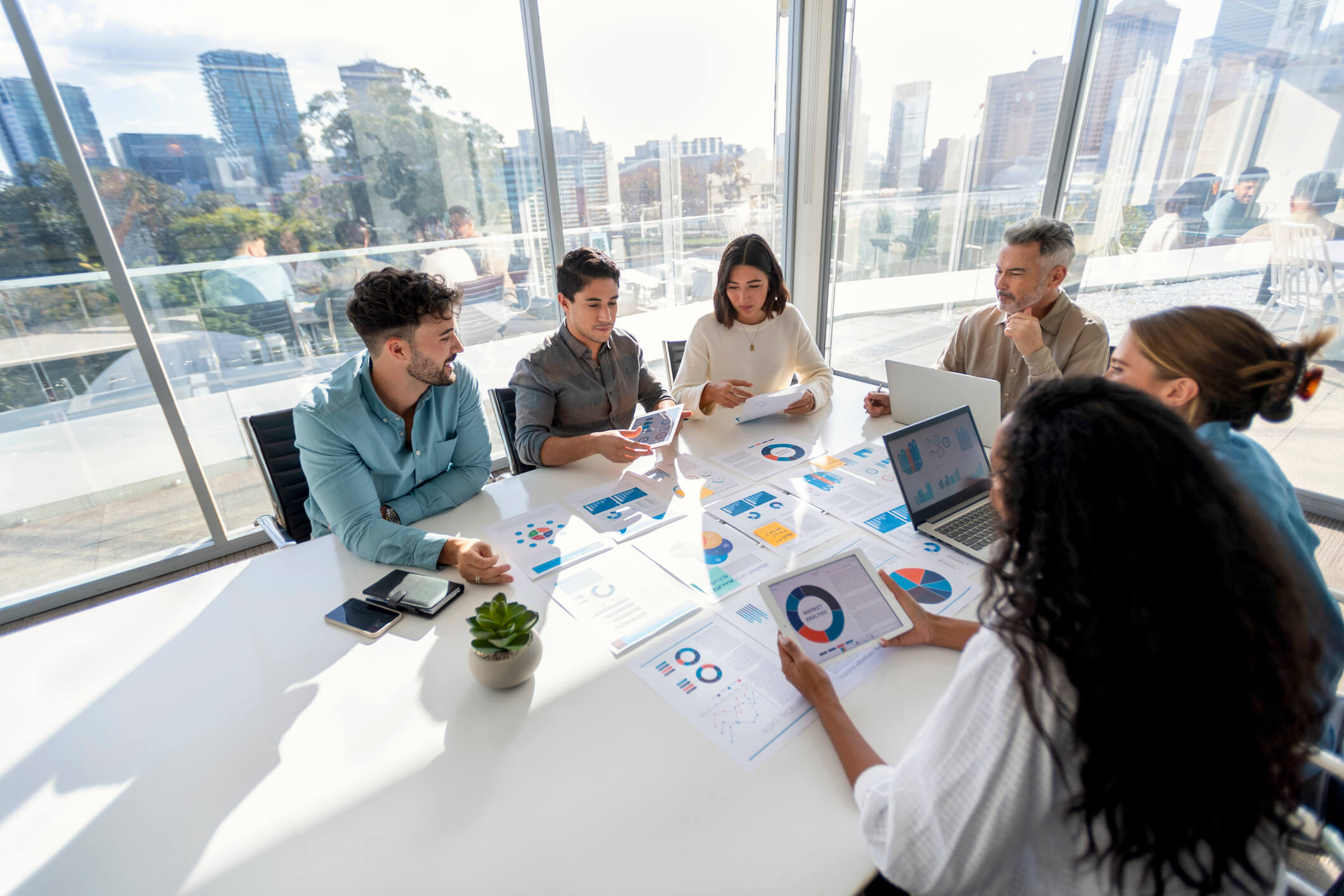 photo of people in office meeting room reviewing a SaaS ROI presentation