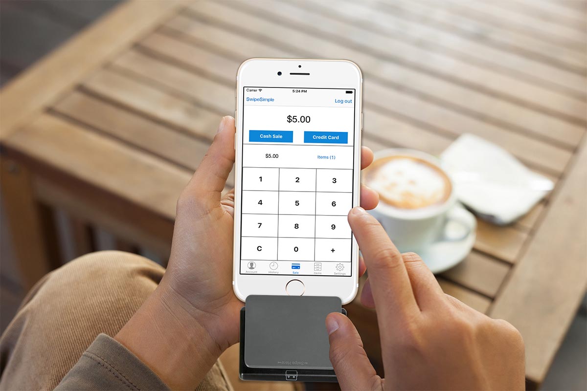 phone screen while person compares Xplor Pay vs Square merchant services