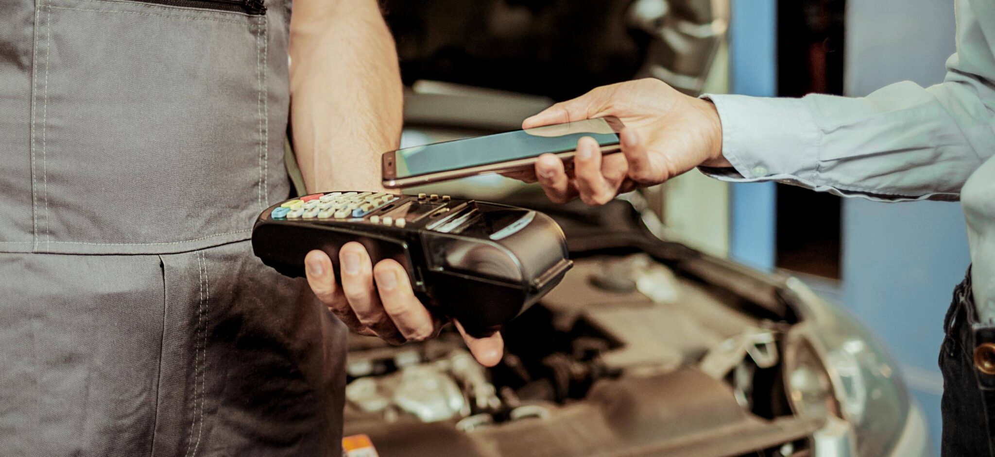 Person completing payment for automotive repair