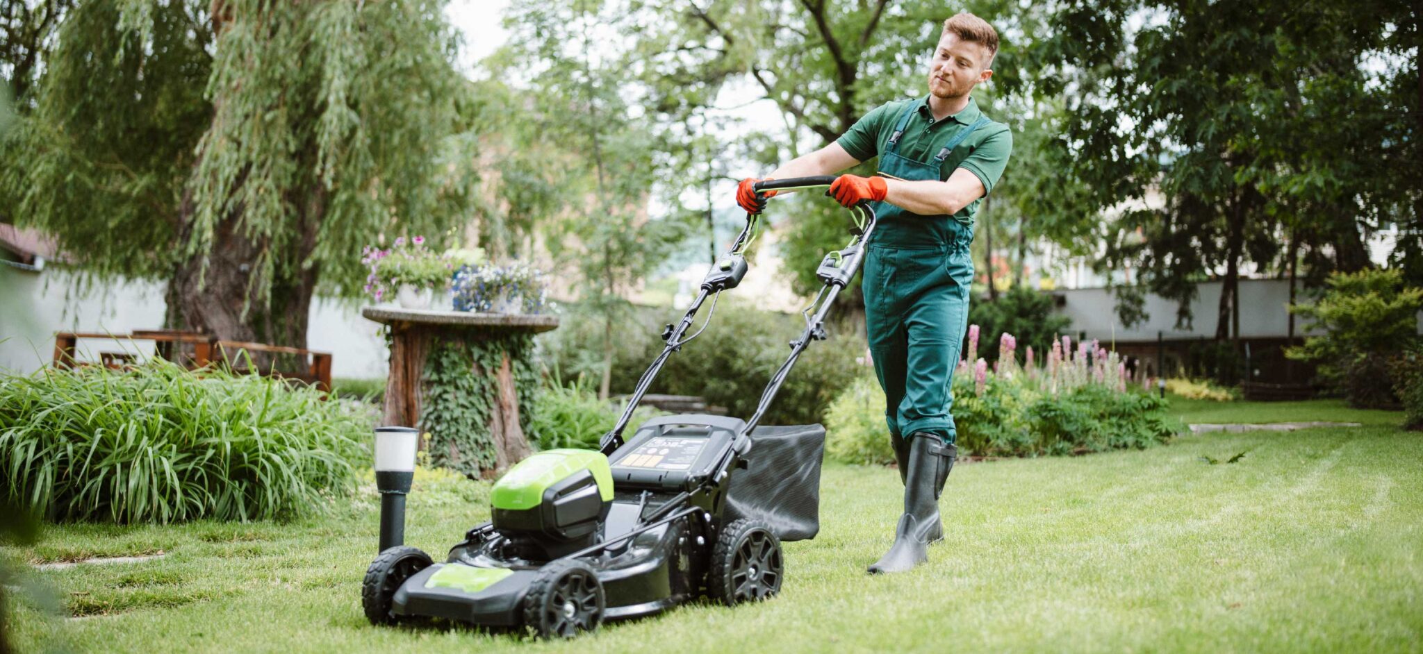 Field Service worker mowing the lawn