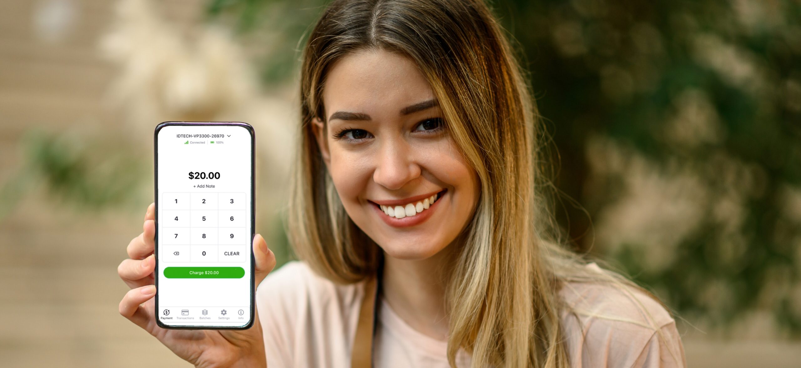 Woman holding mobile phone with credit card payment on screen
