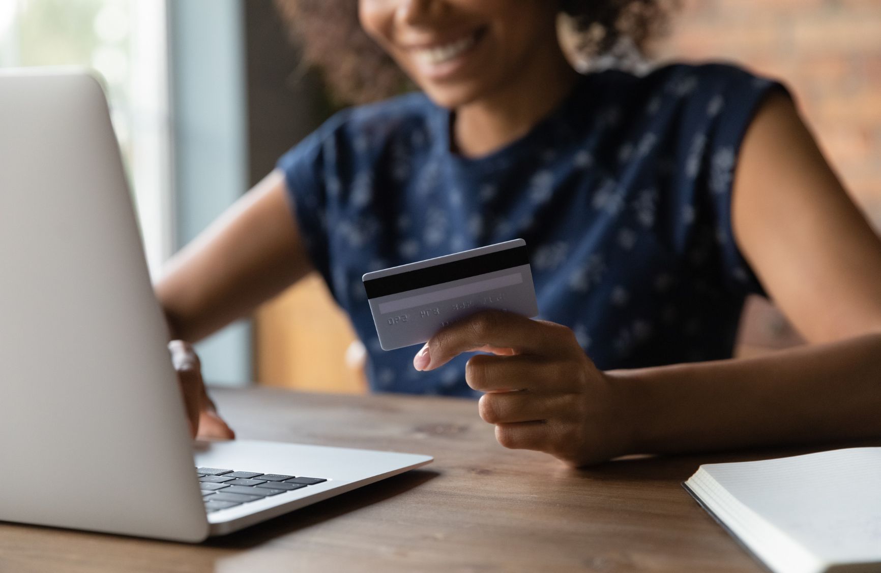 Woman entering credit card information on a laptop